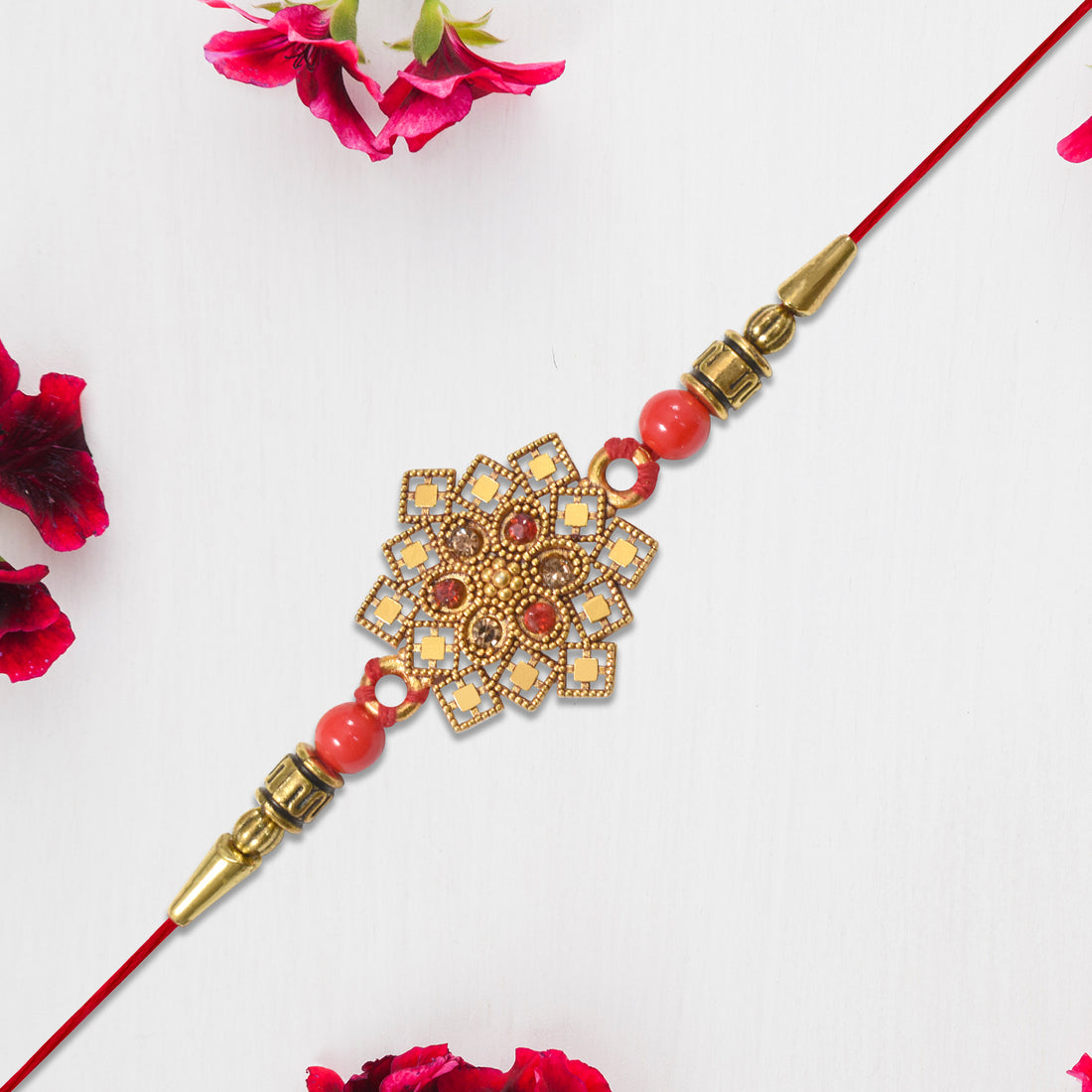 Traditional Golden Floral Rakhi With Intricate Design And Red Beads On Red Thread